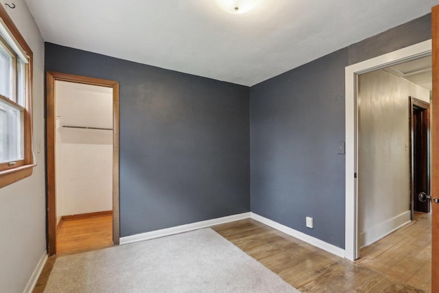 N62W23527 Sliver Spring Dr, Sussex, WI 53089 - unfurnished bedroom with wood finished floors and baseboards