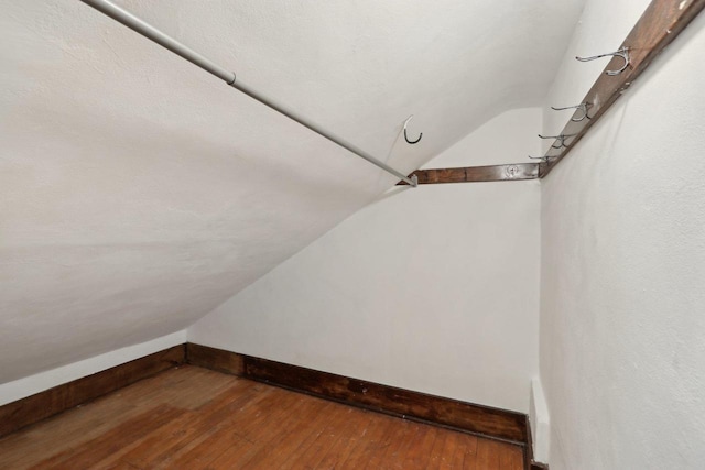 N62W23527 Sliver Spring Dr, Sussex, WI 53089 - additional living space with vaulted ceiling, wood-type flooring, and baseboards