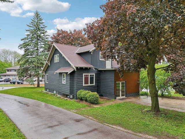N62W23527 Sliver Spring Dr, Sussex, WI 53089 - view of front facade with a front yard, french doors, and a shingled roof