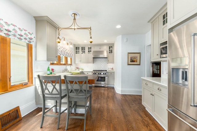 529 N 68th St, Wauwatosa, WI 53213 - dining space featuring baseboards, dark wood-type flooring, a chandelier, and recessed lighting