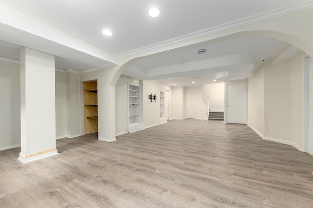 529 N 68th St, Wauwatosa, WI 53213 - unfurnished living room featuring baseboards, arched walkways, wood finished floors, stairway, and recessed lighting