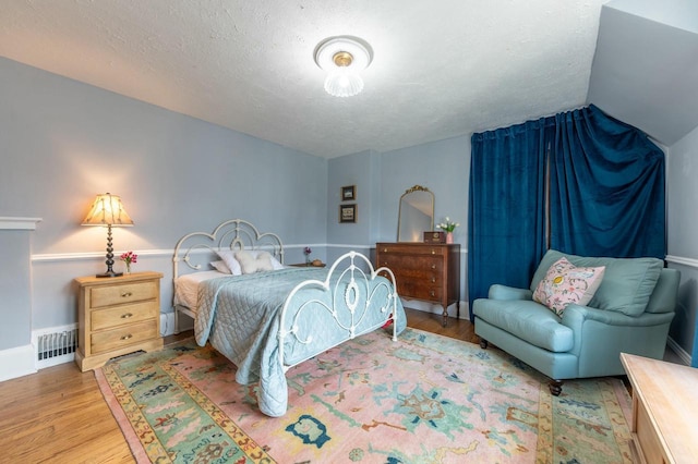 529 N 68th St, Wauwatosa, WI 53213 - bedroom featuring wood finished floors, a textured ceiling, lofted ceiling, and baseboards