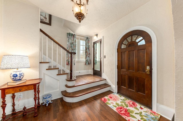 529 N 68th St, Wauwatosa, WI 53213 - foyer entrance with a textured wall, hardwood / wood-style flooring, a textured ceiling, stairway, and baseboards