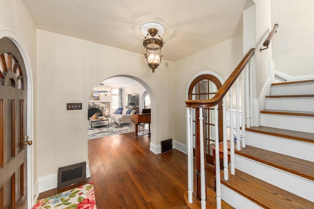 529 N 68th St, Wauwatosa, WI 53213 - entryway with arched walkways, wood finished floors, stairs, and baseboards