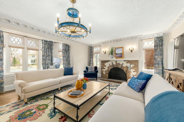 529 N 68th St, Wauwatosa, WI 53213 - living room with a textured ceiling, plenty of natural light, a chandelier, wood finished floors, and a fireplace