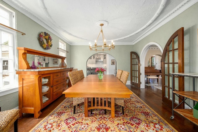 529 N 68th St, Wauwatosa, WI 53213 - dining area featuring a chandelier, wood finished floors, arched walkways, and crown molding