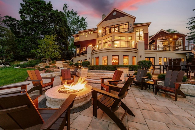 N49W35398 Wisconsin Ave, Oconomowoc, WI 53066 - patio terrace at dusk with a balcony, a fire pit, and a patio