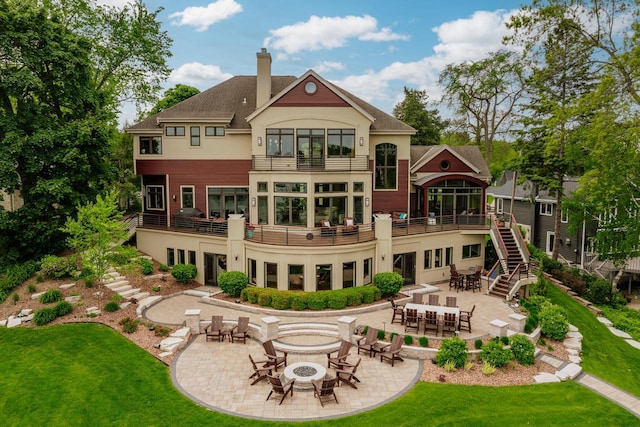 N49W35398 Wisconsin Ave, Oconomowoc, WI 53066 - back of house with an outdoor fire pit, a lawn, and a patio area