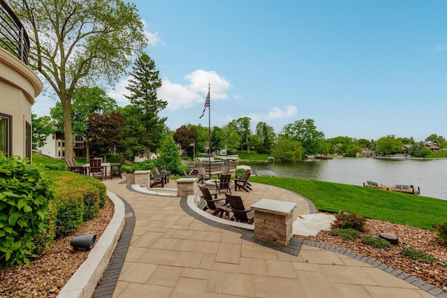 N49W35398 Wisconsin Ave, Oconomowoc, WI 53066 - view of patio / terrace featuring a water view and an outdoor fire pit