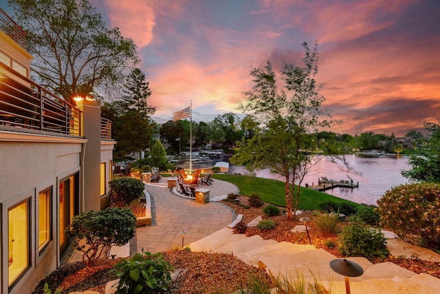 N49W35398 Wisconsin Ave, Oconomowoc, WI 53066 - yard at dusk with a patio, a water view, and an outdoor fire pit
