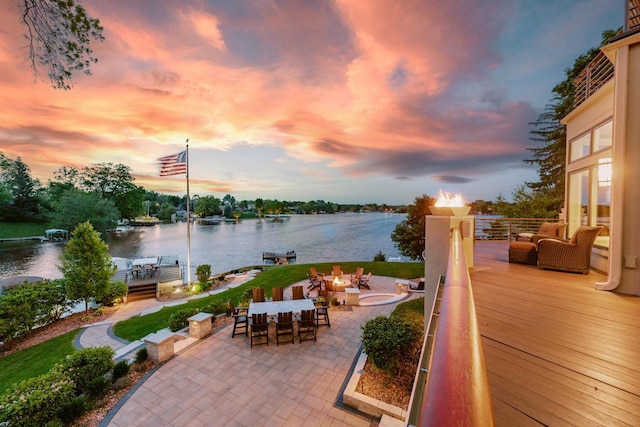 N49W35398 Wisconsin Ave, Oconomowoc, WI 53066 - patio terrace at dusk with a water view, a patio area, a boat dock, and boat lift