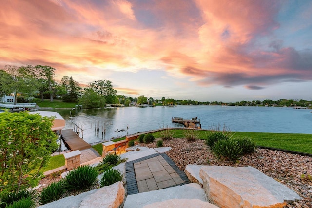 N49W35398 Wisconsin Ave, Oconomowoc, WI 53066 - patio terrace at dusk featuring a boat dock, boat lift, and a water view
