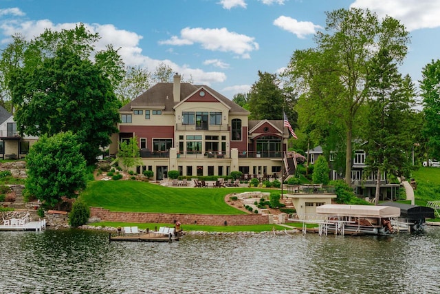 N49W35398 Wisconsin Ave, Oconomowoc, WI 53066 - back of house featuring a water view, a yard, and a balcony