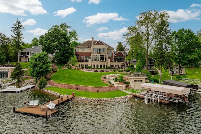 N49W35398 Wisconsin Ave, Oconomowoc, WI 53066 - back of house featuring a water view, a yard, and an attached garage