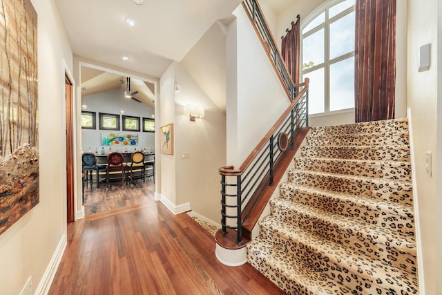 N49W35398 Wisconsin Ave, Oconomowoc, WI 53066 - stairway featuring wood finished floors, plenty of natural light, recessed lighting, baseboards, and ceiling fan