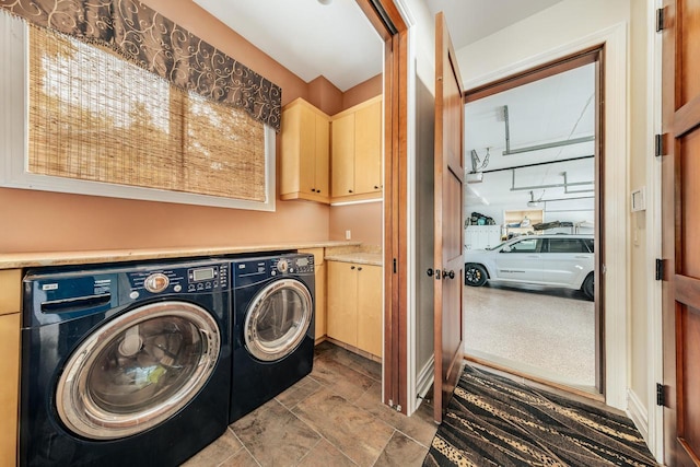 N49W35398 Wisconsin Ave, Oconomowoc, WI 53066 - washroom featuring cabinet space, separate washer and dryer, and stone finish floors