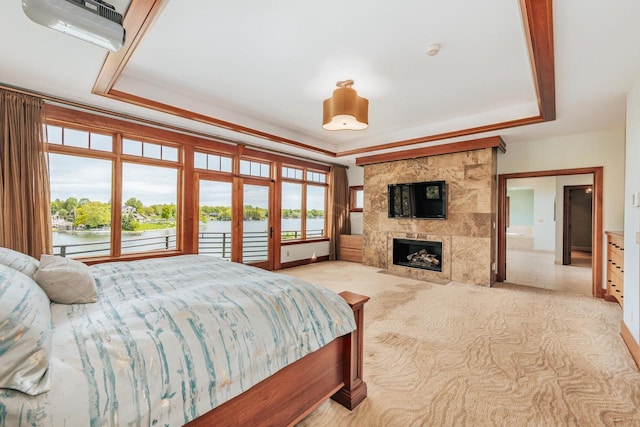 N49W35398 Wisconsin Ave, Oconomowoc, WI 53066 - bedroom with a raised ceiling, a tiled fireplace, and carpet