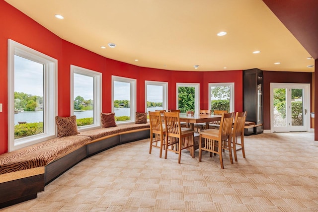 N49W35398 Wisconsin Ave, Oconomowoc, WI 53066 - dining room featuring light colored carpet, recessed lighting, and a water view