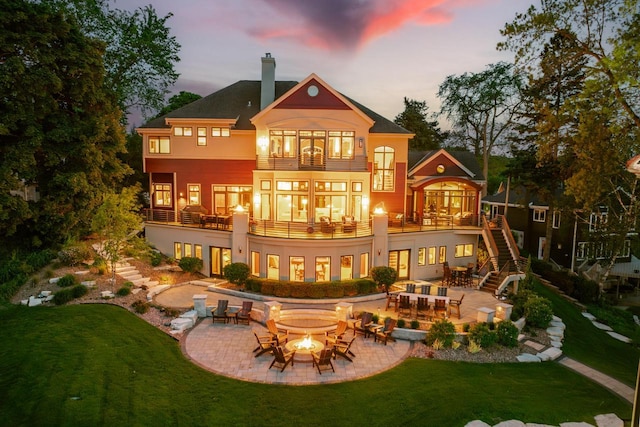 N49W35398 Wisconsin Ave, Oconomowoc, WI 53066 - back of property with a fire pit, a balcony, a patio, and stairs