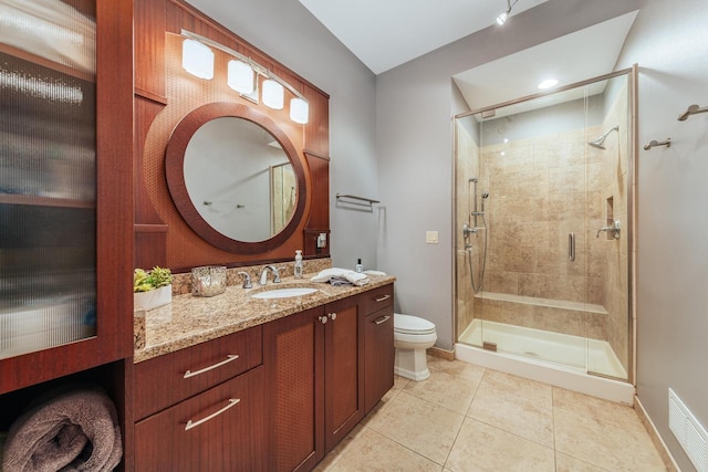 N49W35398 Wisconsin Ave, Oconomowoc, WI 53066 - full bath with a stall shower, toilet, vanity, tile patterned flooring, and baseboards