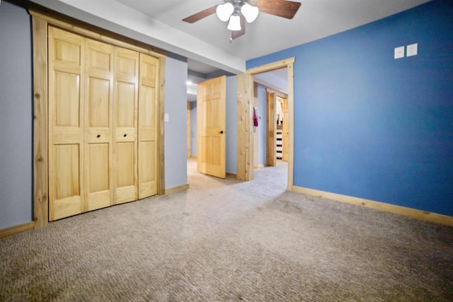 29774 Whispering Pines Rd, Lone Rock, WI 53556 - unfurnished bedroom with carpet flooring, baseboards, a closet, and a ceiling fan