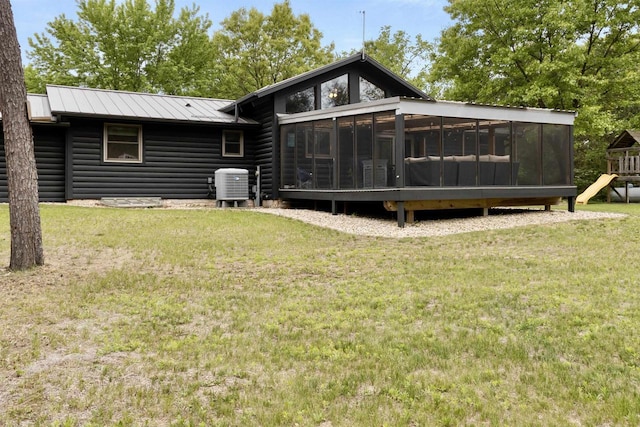 29774 Whispering Pines Rd, Lone Rock, WI 53556 - rear view of house with a sunroom, a playground, faux log siding, and a yard