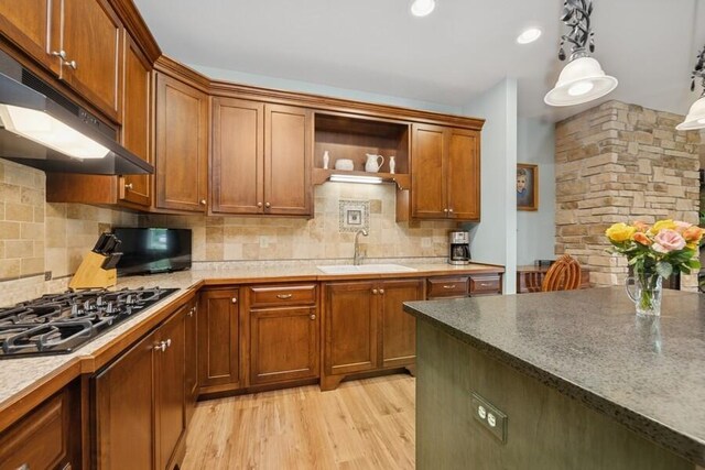 W522 Highland Rd, Genoa City, WI 53128 - kitchen with a sink, black gas cooktop, backsplash, light wood finished floors, and exhaust hood