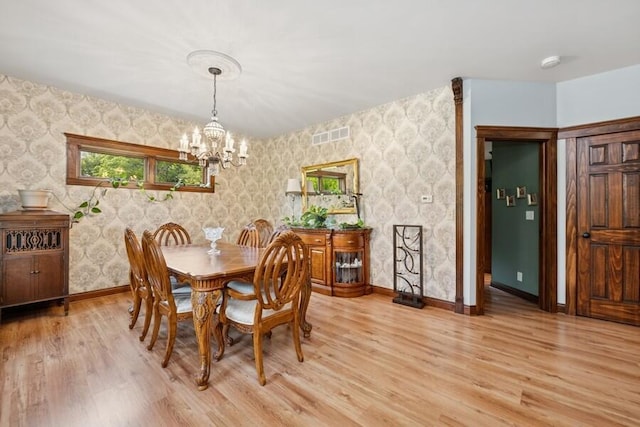 W522 Highland Rd, Genoa City, WI 53128 - dining space with wallpapered walls, a chandelier, light wood-style flooring, and baseboards
