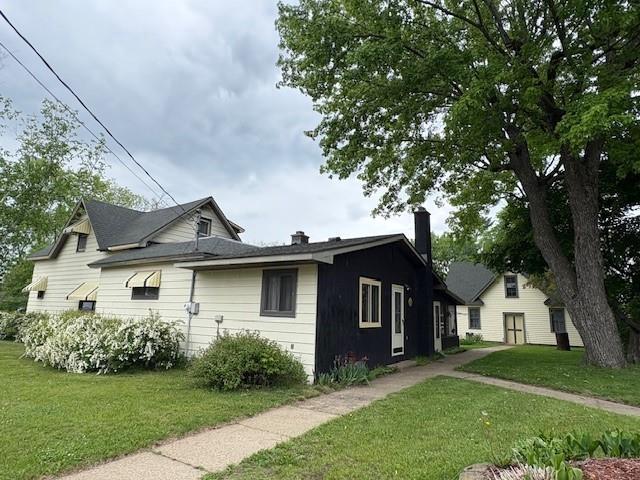 211 Church St, Taylor, WI 54659 - view of side of property with a lawn and a chimney