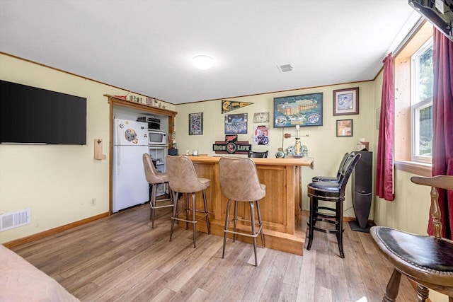 3005 S St, East Troy, WI 53120 - indoor dry bar featuring white appliances, light wood-type flooring, and baseboards