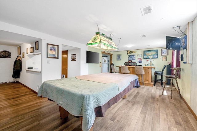 3005 S St, East Troy, WI 53120 - recreation room with hardwood / wood-style floors, bar, and baseboards
