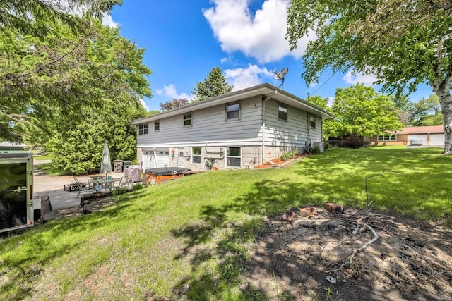 3005 S St, East Troy, WI 53120 - back of property featuring a hot tub and a lawn