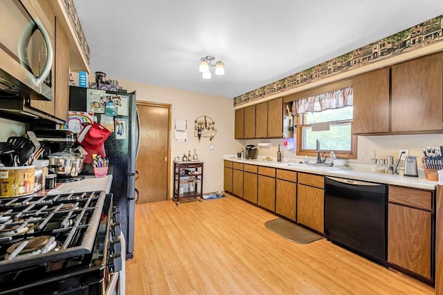 3005 S St, East Troy, WI 53120 - kitchen featuring stainless steel microwave, dishwasher, gas stove, light countertops, and light wood-style flooring