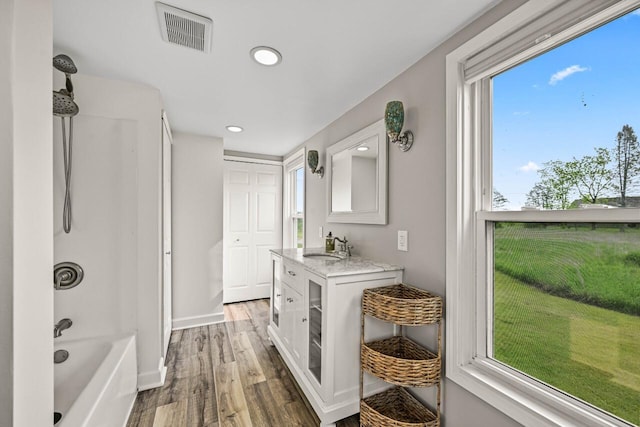24324 W Overson Rd, Union Grove, WI 53182 - bathroom with wood finished floors, vanity, recessed lighting, washtub / shower combination, and baseboards
