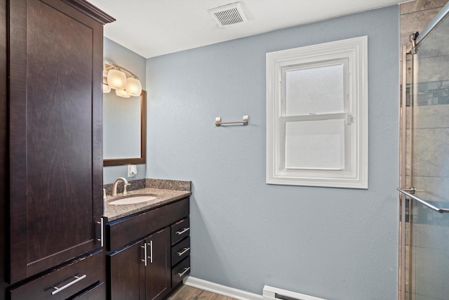 915 E Ohio Ave, Milwaukee, WI 53207 - bathroom featuring vanity, tiled shower, wood finished floors, and baseboards