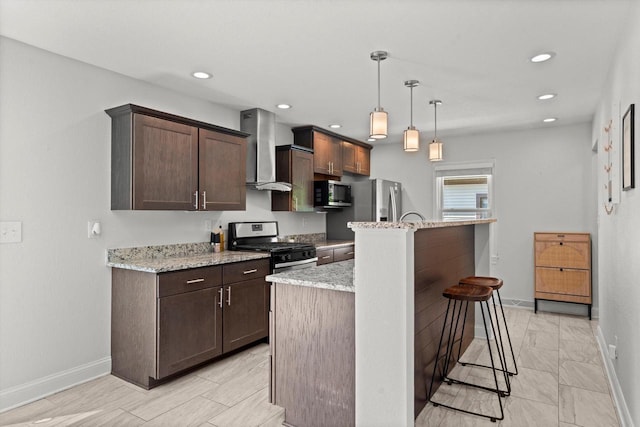 915 E Ohio Ave, Milwaukee, WI 53207 - kitchen with wall chimney range hood, stainless steel appliances, baseboards, a kitchen breakfast bar, and recessed lighting
