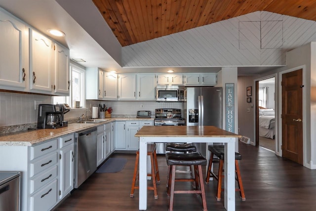 N1416 W Stratton Rd, Waupaca, WI 54981 - kitchen with stainless steel appliances, wooden ceiling, a sink, decorative backsplash, and dark wood-type flooring
