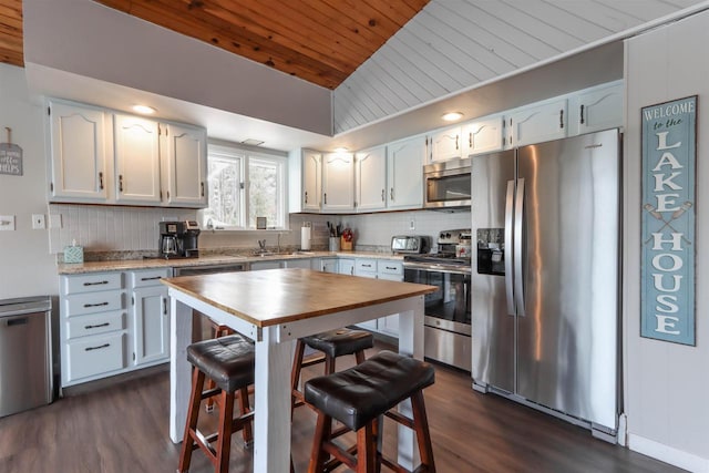 N1416 W Stratton Rd, Waupaca, WI 54981 - kitchen featuring appliances with stainless steel finishes, wooden ceiling, dark wood finished floors, decorative backsplash, and lofted ceiling