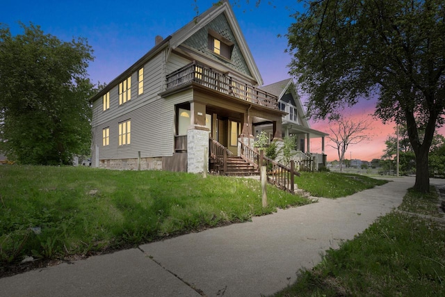 3381 N 26th St Unit 3383, Milwaukee, WI 53206 - view of front of property with a balcony, a chimney, and a yard