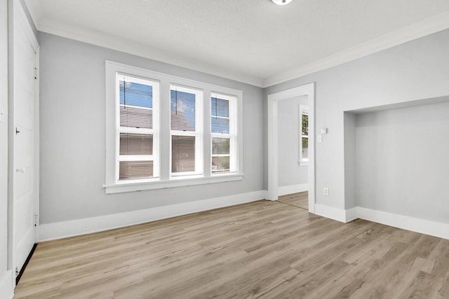 3381 N 26th St Unit 3383, Milwaukee, WI 53206 - unfurnished bedroom with crown molding, light wood-type flooring, baseboards, and a textured ceiling