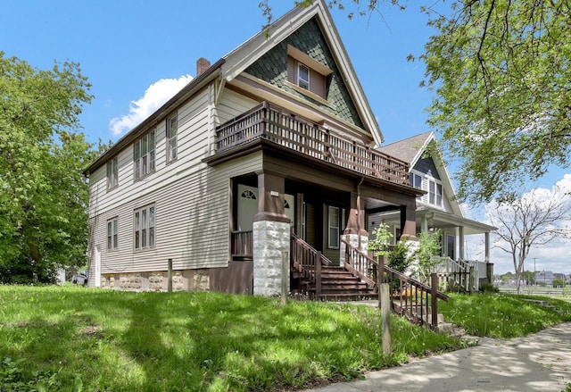 3381 N 26th St Unit 3383, Milwaukee, WI 53206 - victorian house featuring a balcony, a chimney, and a porch
