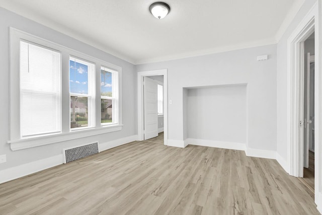 3381 N 26th St Unit 3383, Milwaukee, WI 53206 - unfurnished bedroom with light wood-style floors, baseboards, and ornamental molding