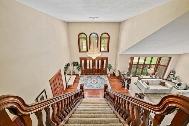 S82W15980 Bass Bay Ln, Muskego, WI 53150 - foyer entrance featuring wood finished floors, plenty of natural light, a high ceiling, and stairway