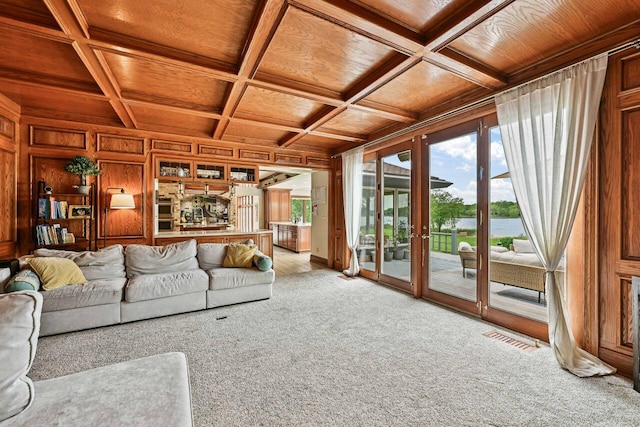 S82W15980 Bass Bay Ln, Muskego, WI 53150 - living room featuring wooden ceiling with exposed beams, light colored carpet, coffered ceiling, wooden walls, and a water view
