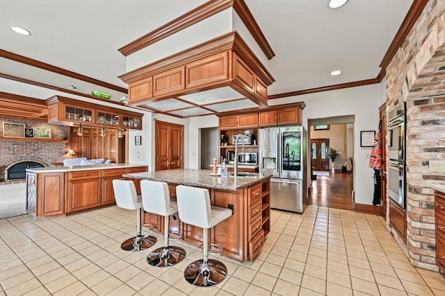 S82W15980 Bass Bay Ln, Muskego, WI 53150 - kitchen featuring appliances with stainless steel finishes, light tile patterned floors, a brick fireplace, crown molding, and open shelves
