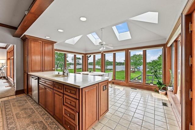 S82W15980 Bass Bay Ln, Muskego, WI 53150 - kitchen with a skylight, a sink, a water view, dishwasher, and light countertops