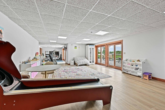 S82W15980 Bass Bay Ln, Muskego, WI 53150 - bedroom with access to outside, french doors, wood finished floors, baseboards, and a drop ceiling