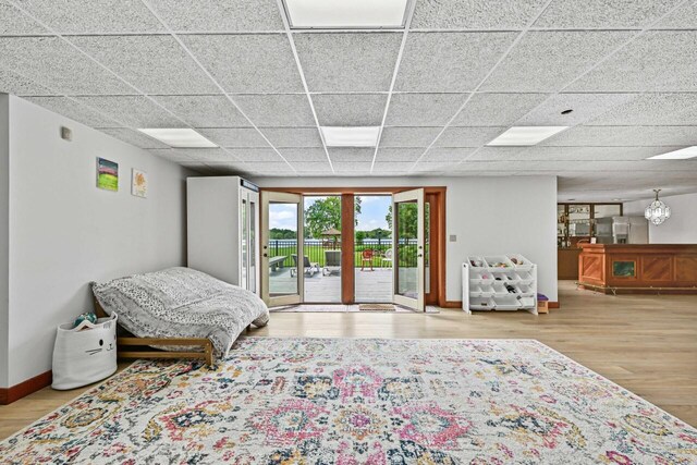 S82W15980 Bass Bay Ln, Muskego, WI 53150 - bedroom with access to exterior, wood finished floors, a drop ceiling, and baseboards