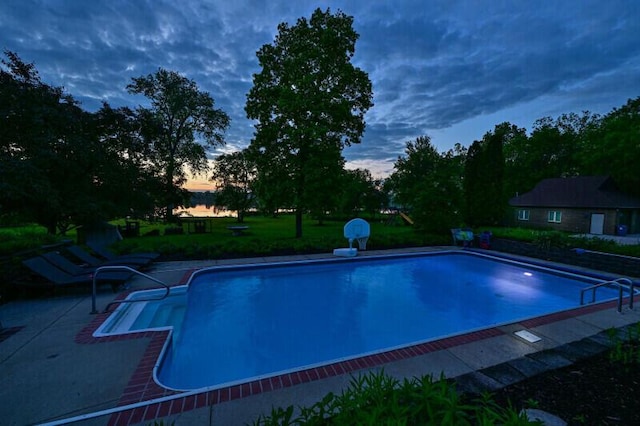 S82W15980 Bass Bay Ln, Muskego, WI 53150 - pool at dusk featuring an outdoor pool and a patio area