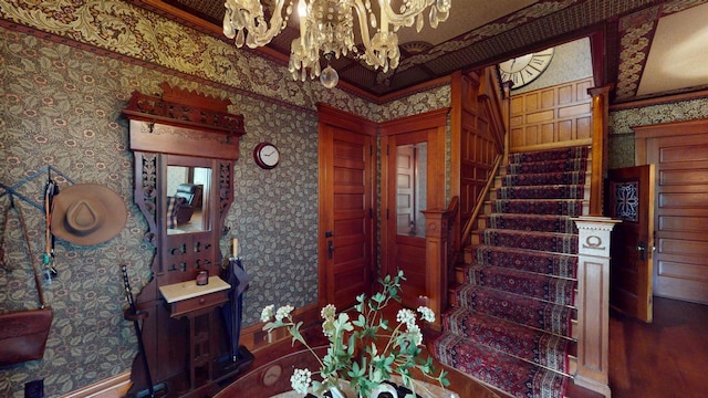 300 S Vine Ave, Marshfield, WI 54449 - entrance foyer featuring a chandelier, stairs, wallpapered walls, ornamental molding, and baseboards